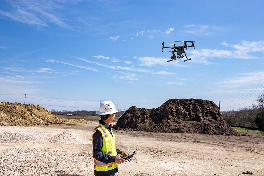 Construction worker flying a drone / road construction