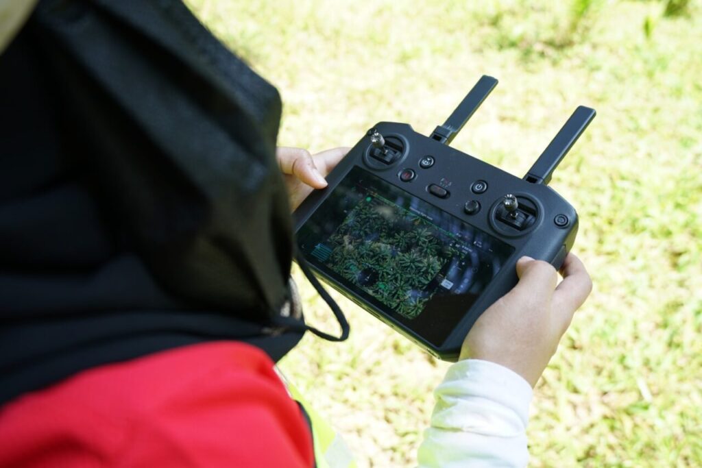 Pilot is monitoring the mapping progress through the remote controller / drone mapping